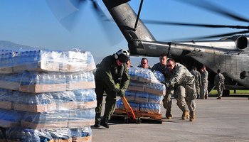 US helicopter, personnel with relief supplies