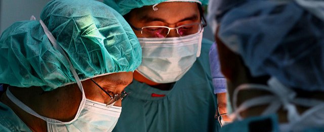 Surgeons in theatre wearing masks