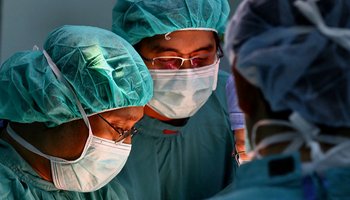 Surgeons in theatre wearing masks