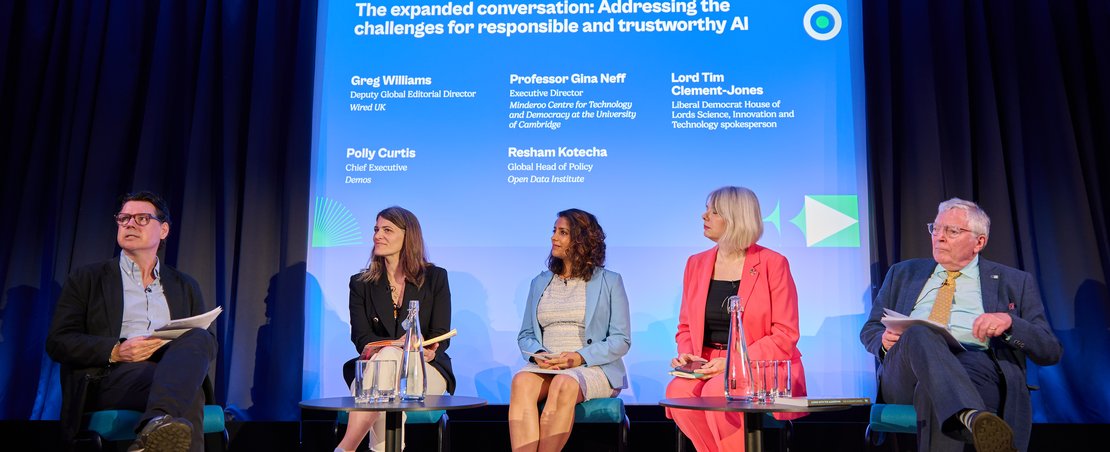 Guests on stage speaking at the AI Summit Fringe in June 2024