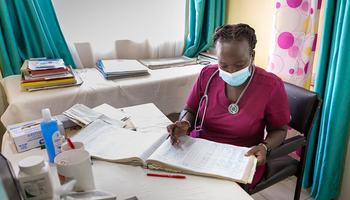 A medical consultant goes through records at Nairobi West Prison Clinic