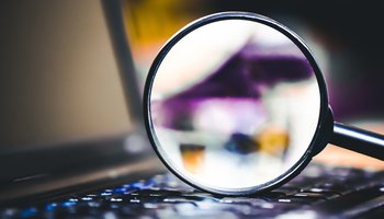 Magnifying glass on computer keyboard