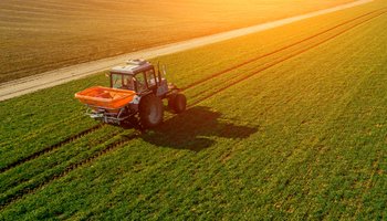 tractor on a green field. aerial survey of agriculture