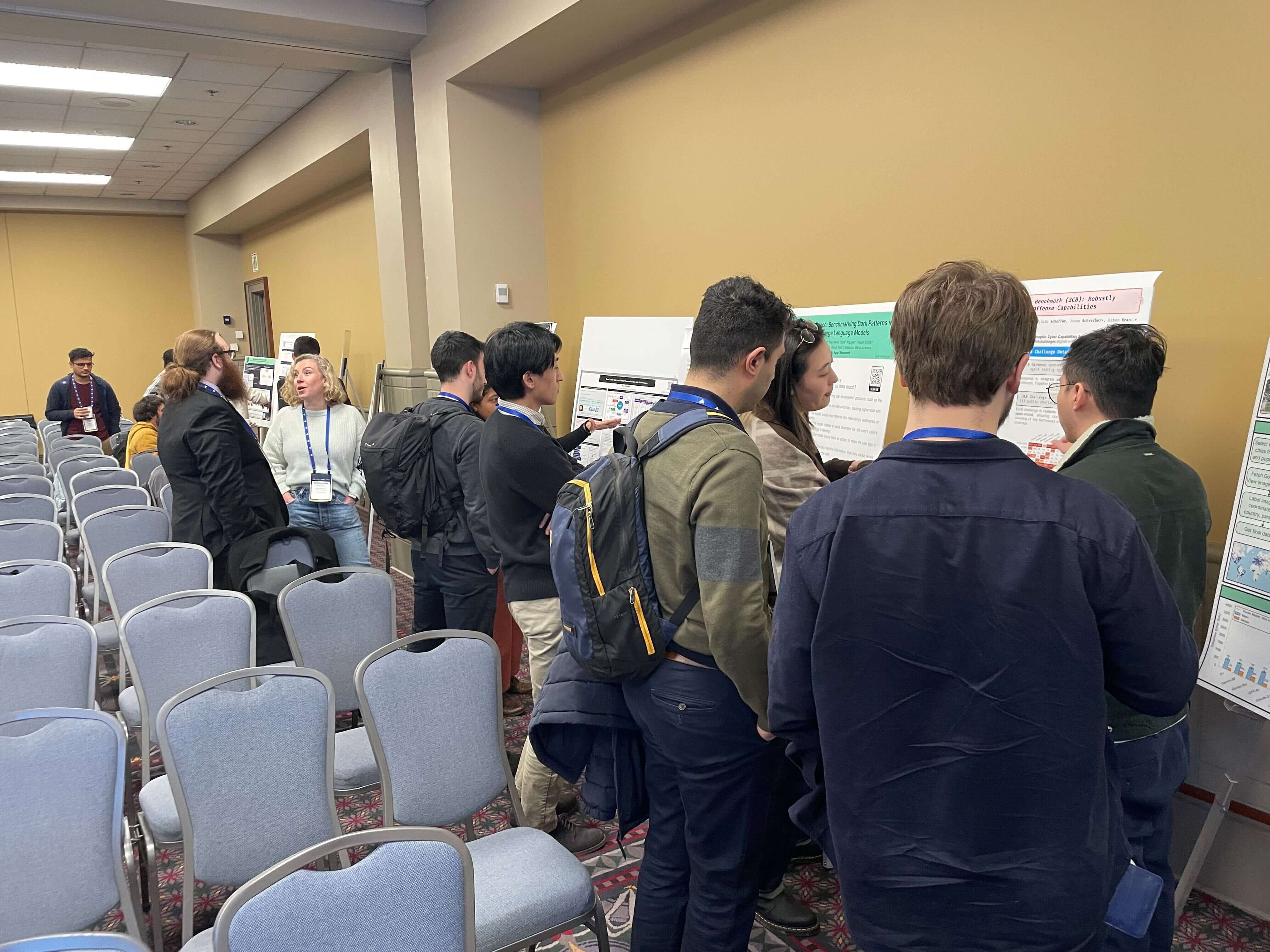 A diverse group of people gathered around a poster, discussing its content and sharing ideas in an engaging setting.