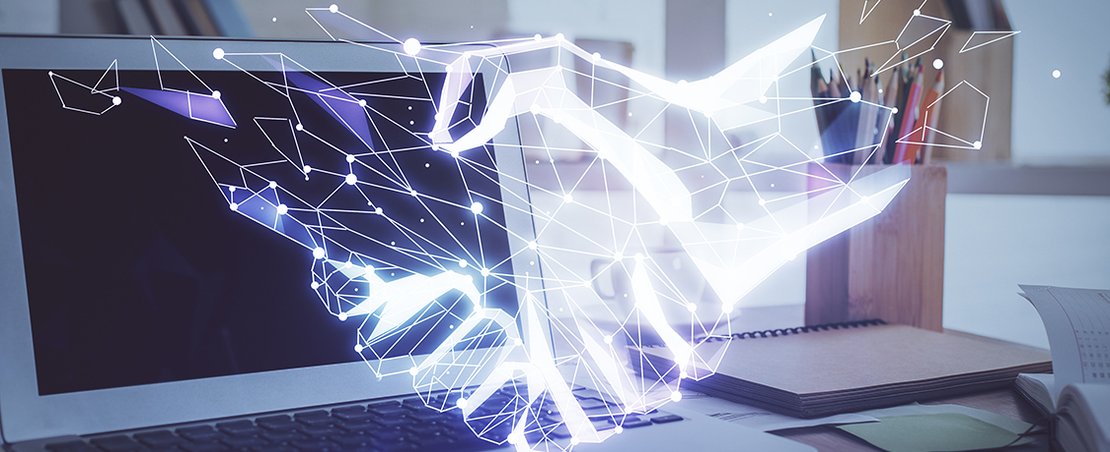 Desktop computer background in office and handshake hologram drawing. Double exposure. Pertnership concept.