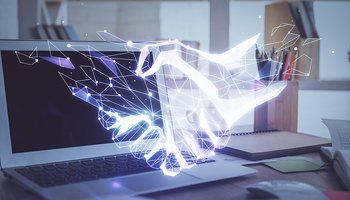 Desktop computer background in office and handshake hologram drawing. Double exposure. Pertnership concept.