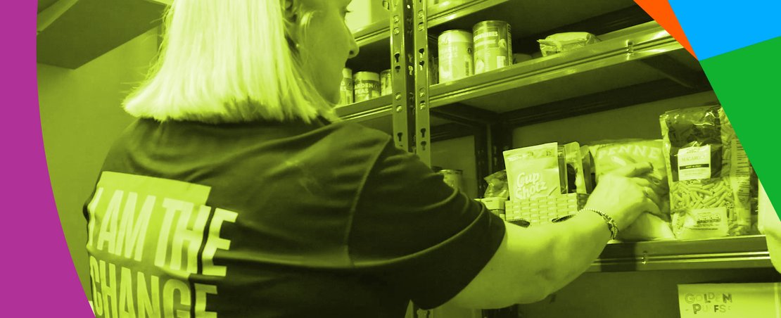 Woman picking up food from a shelf in a food bank with a graphic overlay of a pie chart