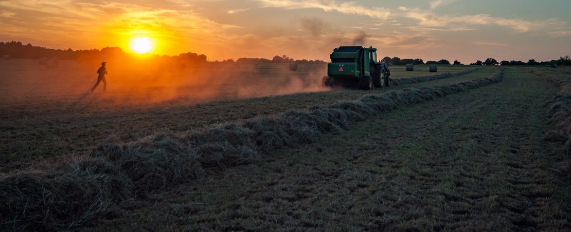 Field and tractor and sunset