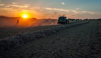 Field and tractor and sunset