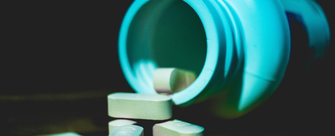 Pill/capsules spilling out of a pot