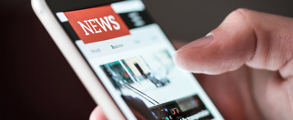 Mobile news application in smartphone. Man reading online news o