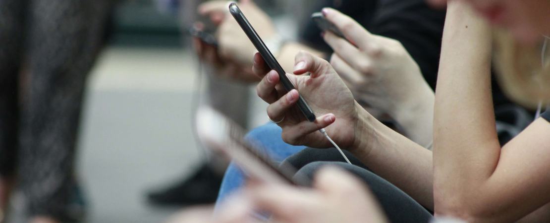 Young people looking at the mobile phones