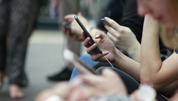 Young people looking at the mobile phones