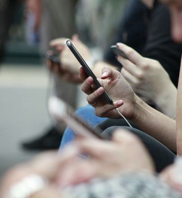 Young people looking at the mobile phones